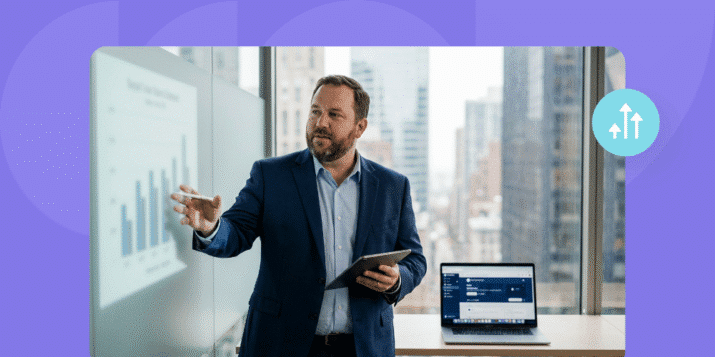 Marketing director standing in a corner office by a window, pointing at analytics on a tablet with a laptop showing subtle social engagement dashboards in the background, warm natural light and navy-accent color grading.